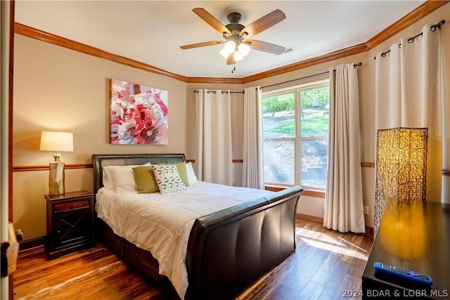 bedroom with ceiling fan, ornamental molding, and wood-type flooring