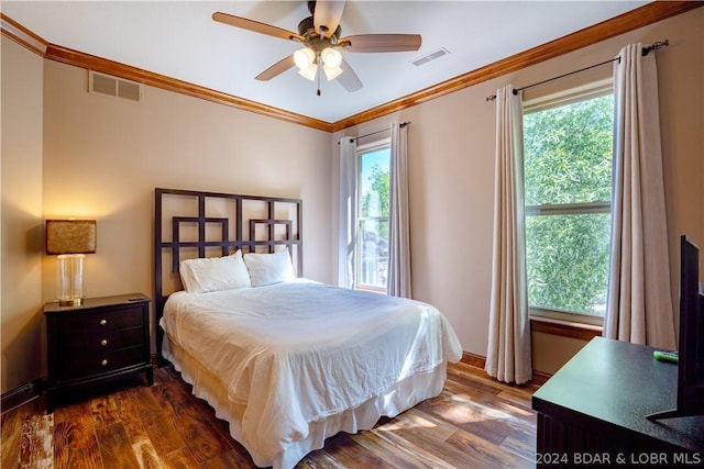 bedroom with multiple windows, ornamental molding, and dark wood-type flooring