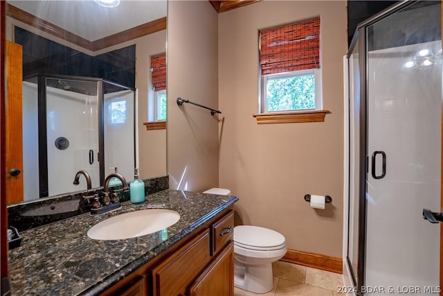 bathroom featuring a shower with door, vanity, tile patterned floors, and toilet