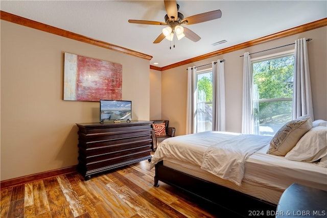 bedroom featuring hardwood / wood-style flooring, ceiling fan, and ornamental molding