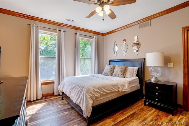 bedroom featuring crown molding, wood-type flooring, and ceiling fan