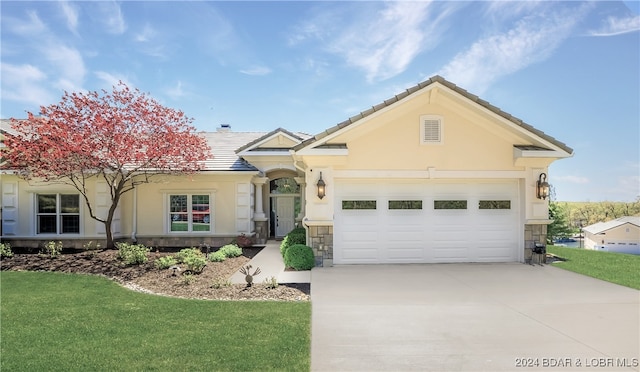 view of front of house with a garage and a front lawn