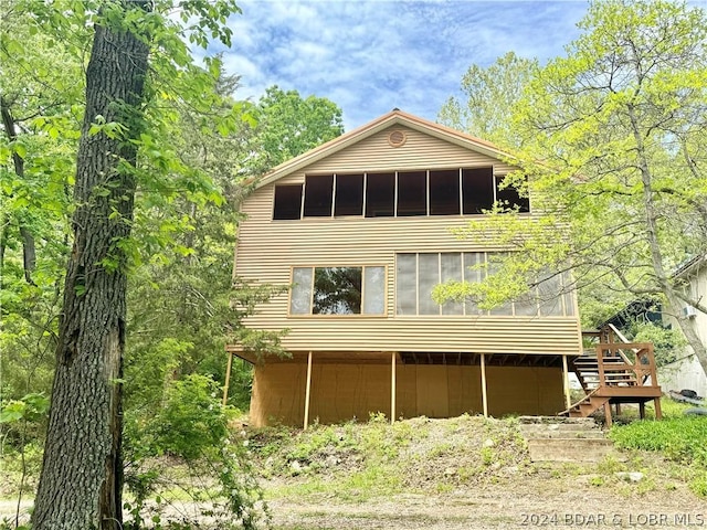 rear view of property with a sunroom