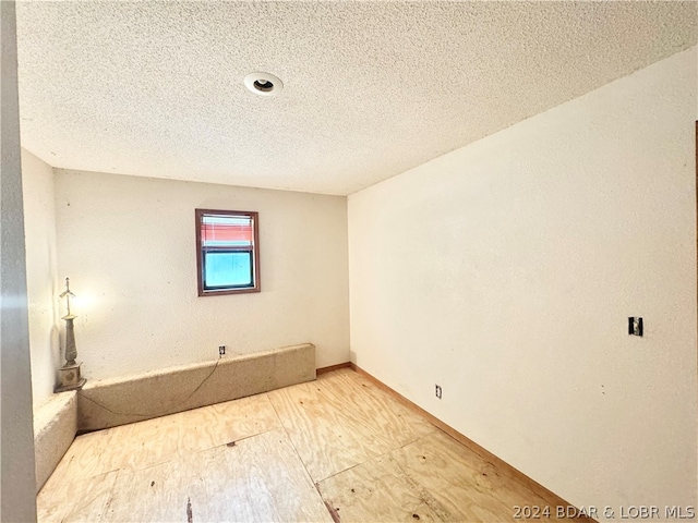 spare room featuring a textured ceiling