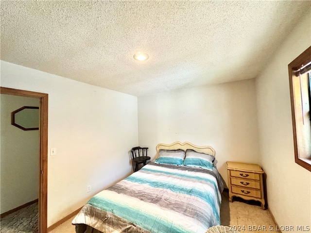 carpeted bedroom with a textured ceiling