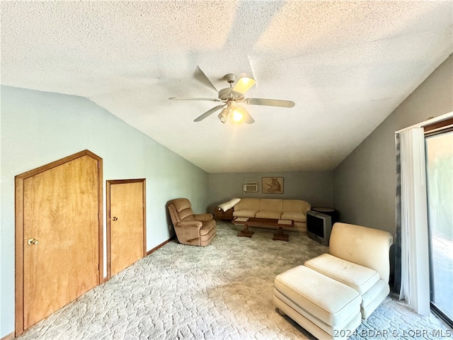 living area featuring a textured ceiling, ceiling fan, light colored carpet, and lofted ceiling