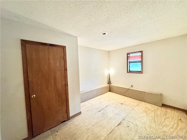 spare room with a textured ceiling