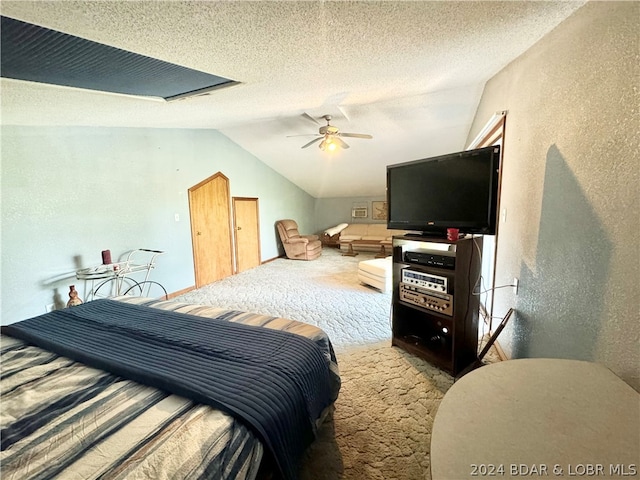 bedroom featuring carpet flooring, a textured ceiling, vaulted ceiling, and ceiling fan