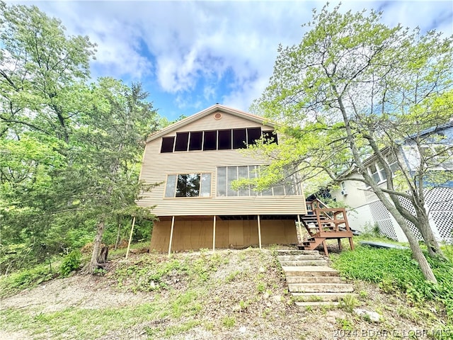 back of house with a sunroom