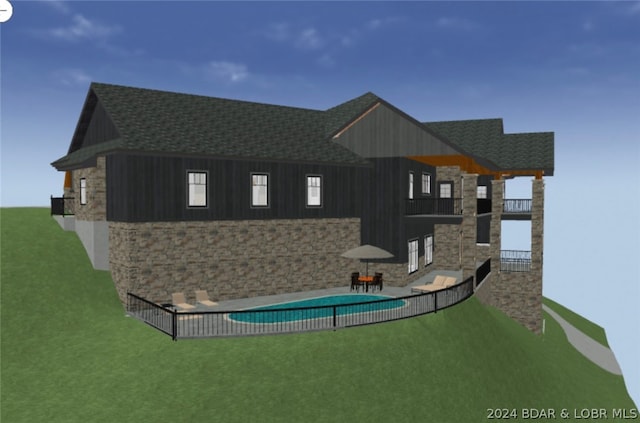 rear view of house featuring a yard, a fenced in pool, and a patio