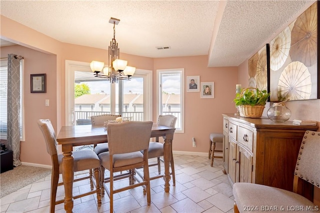 dining area with stone tile floors, visible vents, and baseboards