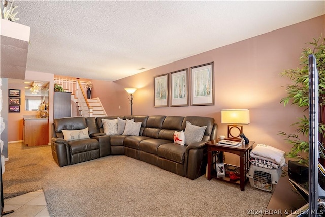 living room featuring light carpet, light tile patterned floors, a textured ceiling, and stairs