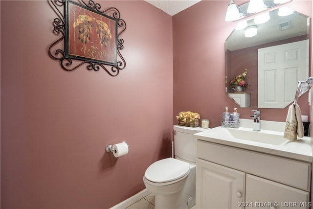 half bathroom with vanity, visible vents, baseboards, tile patterned flooring, and toilet