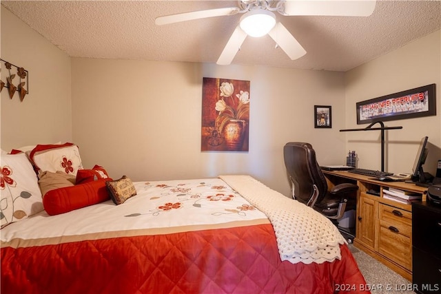 carpeted bedroom featuring a textured ceiling and ceiling fan