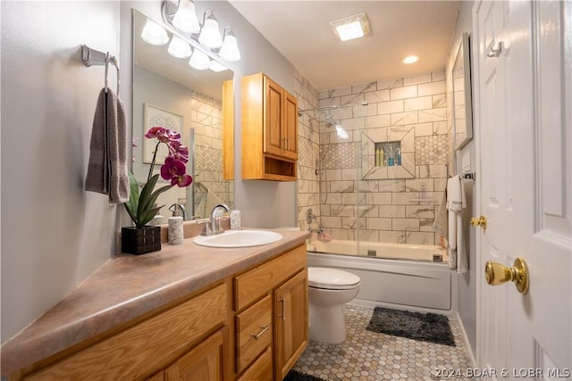 full bath with tile patterned floors, bath / shower combo with glass door, toilet, and vanity