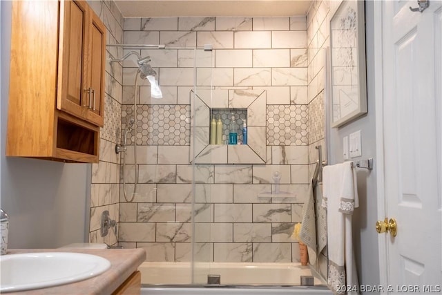 bathroom featuring vanity and bath / shower combo with glass door