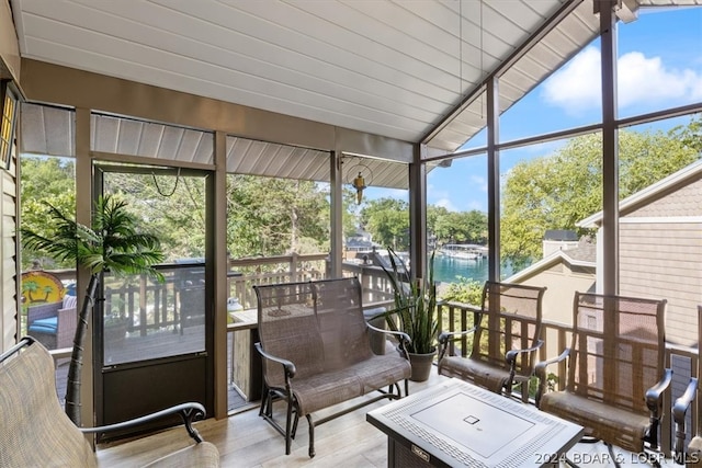 sunroom / solarium featuring lofted ceiling