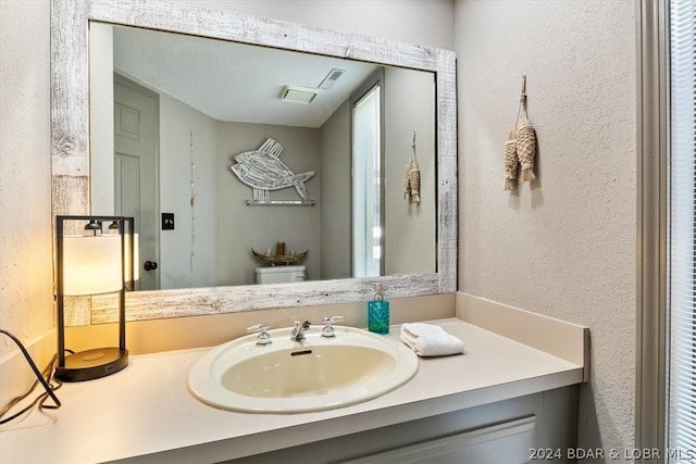 bathroom featuring toilet and vanity