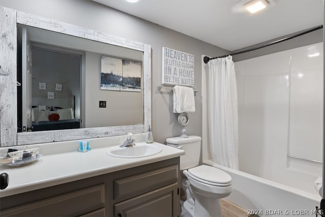 full bathroom featuring shower / tub combo, toilet, and vanity