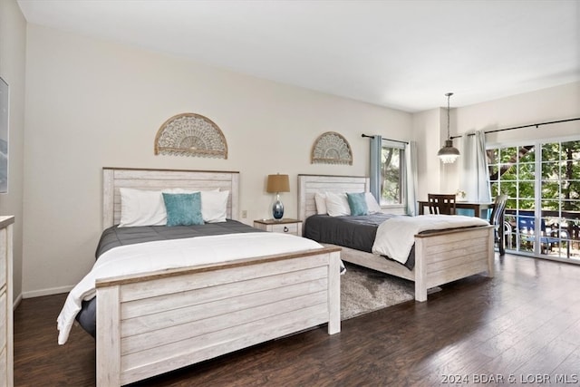 bedroom featuring dark hardwood / wood-style flooring and multiple windows