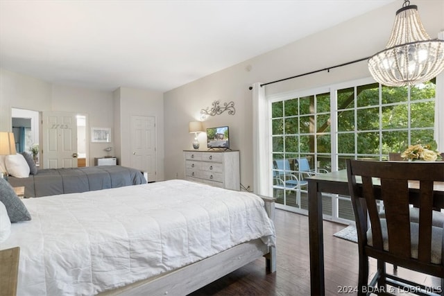 bedroom with wood-type flooring, multiple windows, and an inviting chandelier