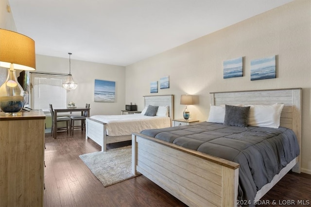 bedroom with dark hardwood / wood-style flooring