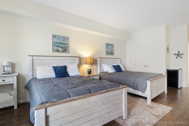 bedroom featuring a closet and dark hardwood / wood-style flooring