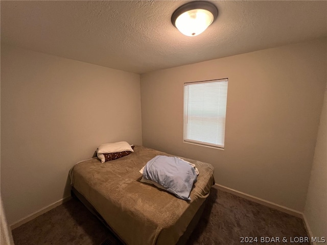 carpeted bedroom with a textured ceiling