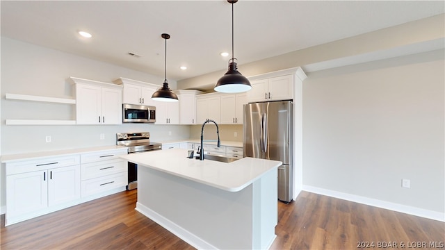 kitchen with sink, white cabinets, hanging light fixtures, and appliances with stainless steel finishes