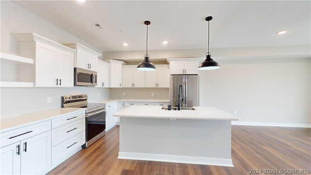 kitchen featuring stainless steel appliances, decorative light fixtures, and white cabinetry