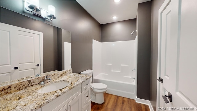 full bathroom featuring toilet, shower / washtub combination, vanity, and hardwood / wood-style flooring