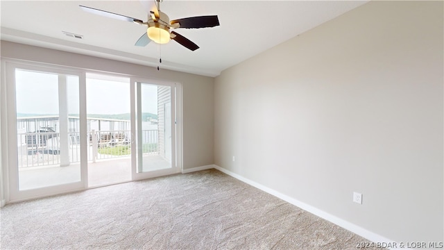 unfurnished room featuring ceiling fan and carpet