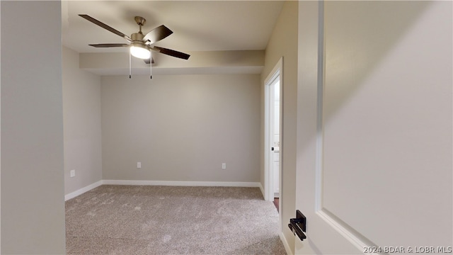 carpeted empty room featuring ceiling fan