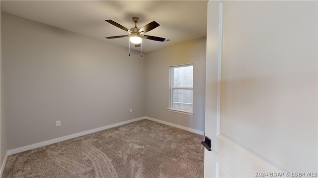 unfurnished room featuring ceiling fan and light colored carpet