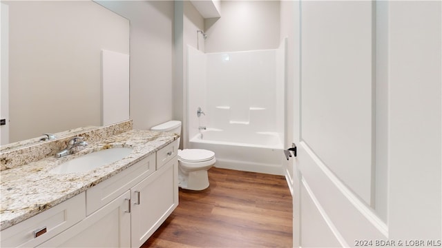 full bathroom featuring shower / bathing tub combination, vanity, toilet, and hardwood / wood-style floors