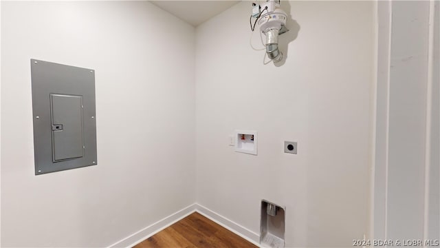 clothes washing area featuring washer hookup, hookup for an electric dryer, wood-type flooring, and electric panel