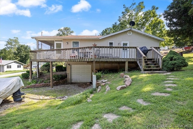 back of house featuring a lawn and a wooden deck