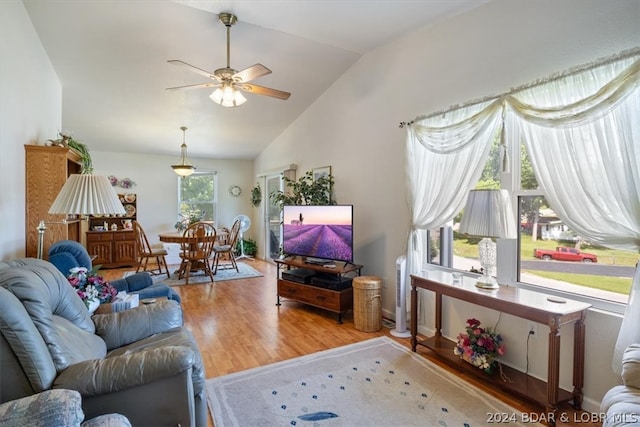 living room with wood-type flooring, ceiling fan, and vaulted ceiling