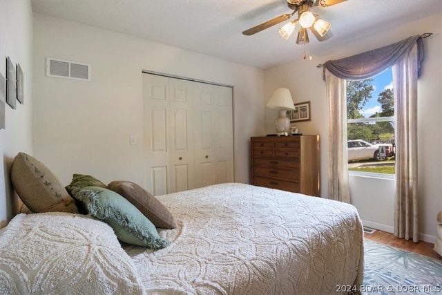 bedroom featuring ceiling fan, a closet, and hardwood / wood-style flooring