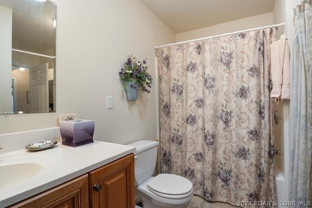 bathroom with toilet and large vanity