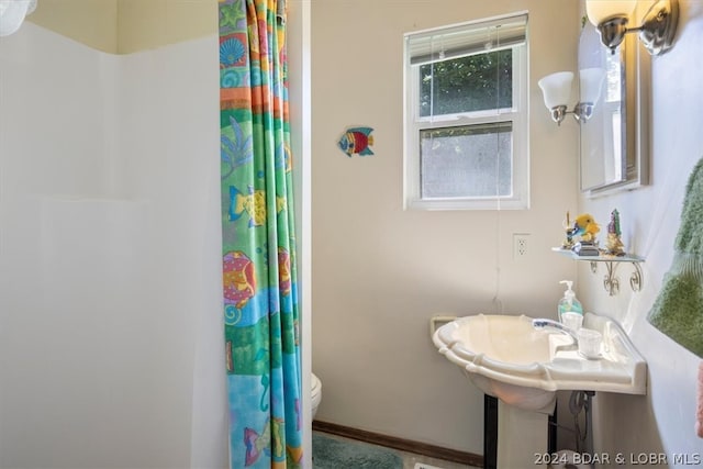 bathroom with plenty of natural light and toilet