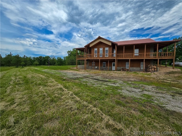 rear view of house featuring a deck