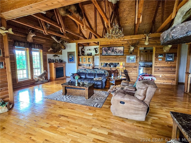 living room featuring beam ceiling, wood ceiling, hardwood / wood-style flooring, and high vaulted ceiling