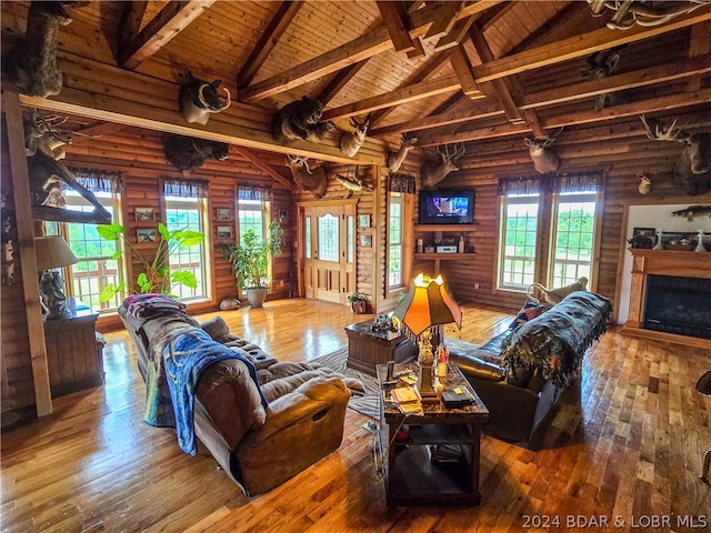 living room with wood-type flooring, wooden ceiling, and plenty of natural light