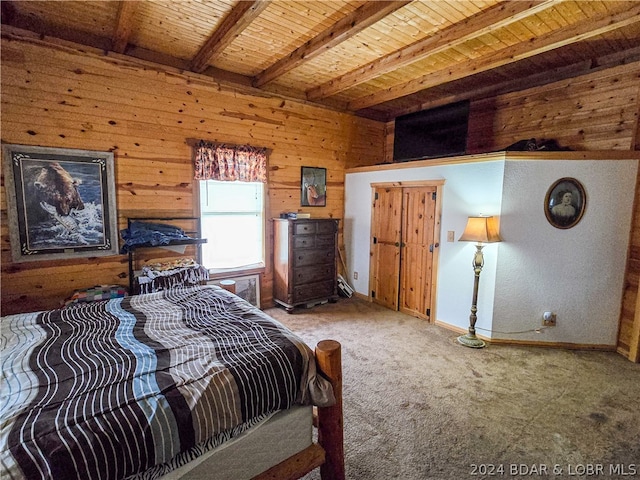 carpeted bedroom with beamed ceiling, wooden walls, and wooden ceiling