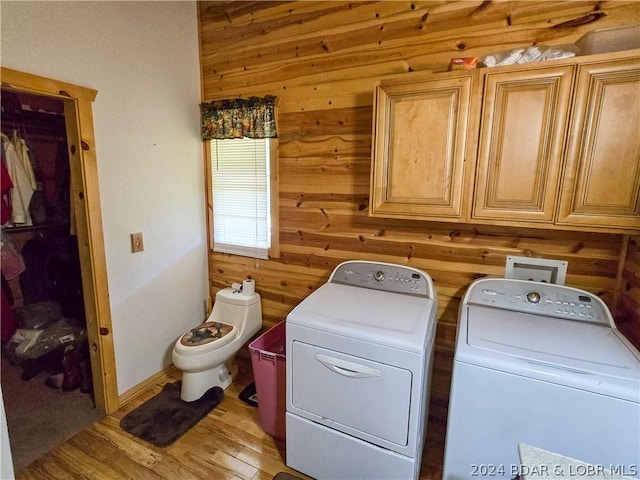 27271 Little Buffalo Rd, Stover, MO 65078 - clothes washing area featuring wooden walls, washer and dryer, light wood-type flooring, and laundry area