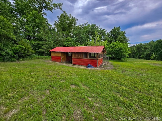 view of outbuilding with a lawn