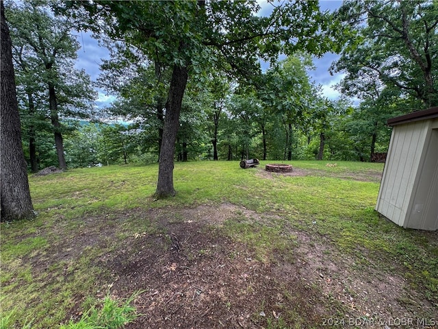 view of yard with a fire pit