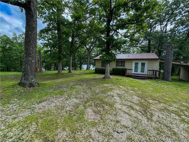 view of yard featuring french doors and a deck