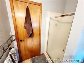 bathroom with a shower with shower door and a mail area